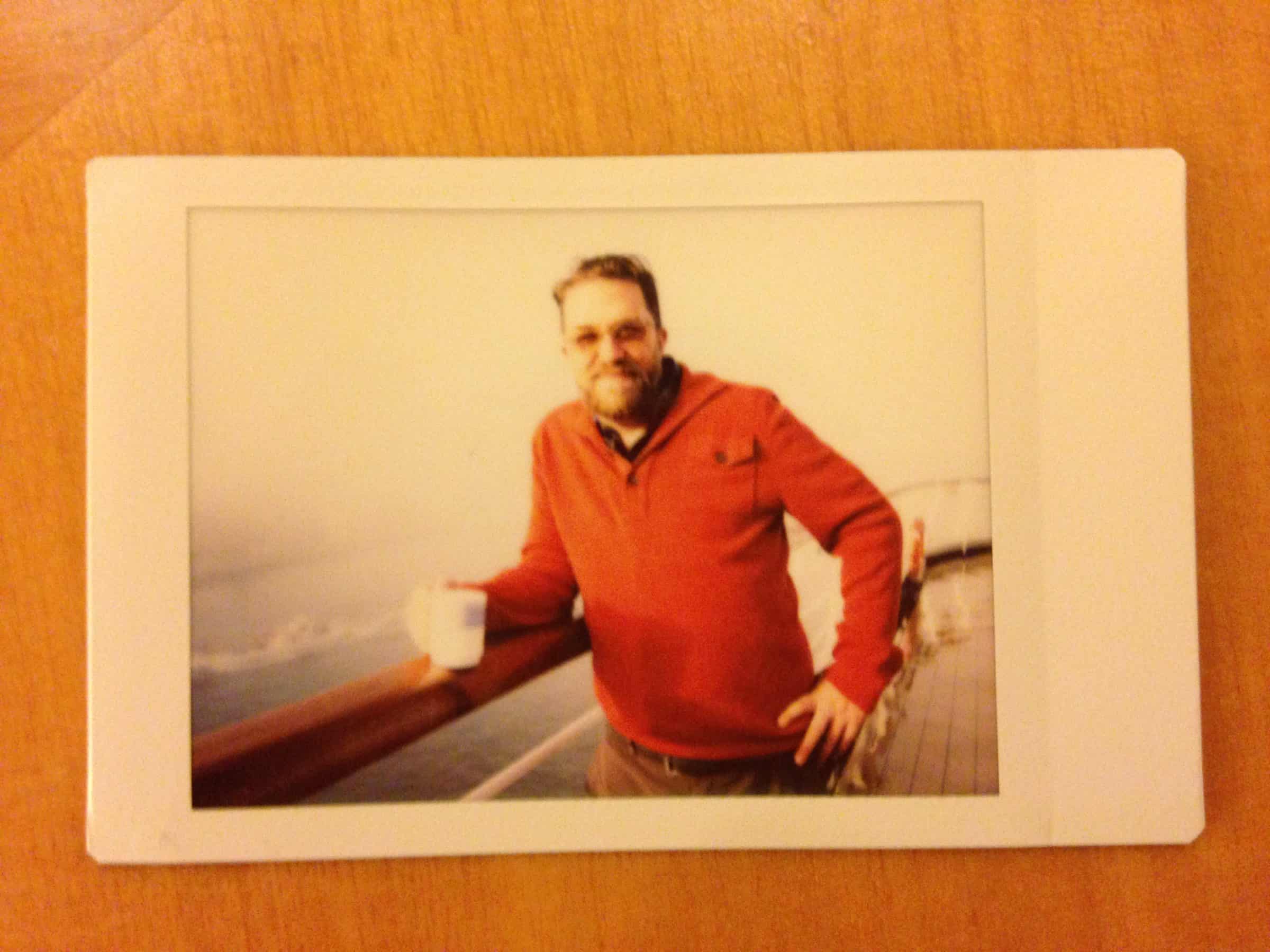 At Sea: Leaning with mug and orange sweater, 1