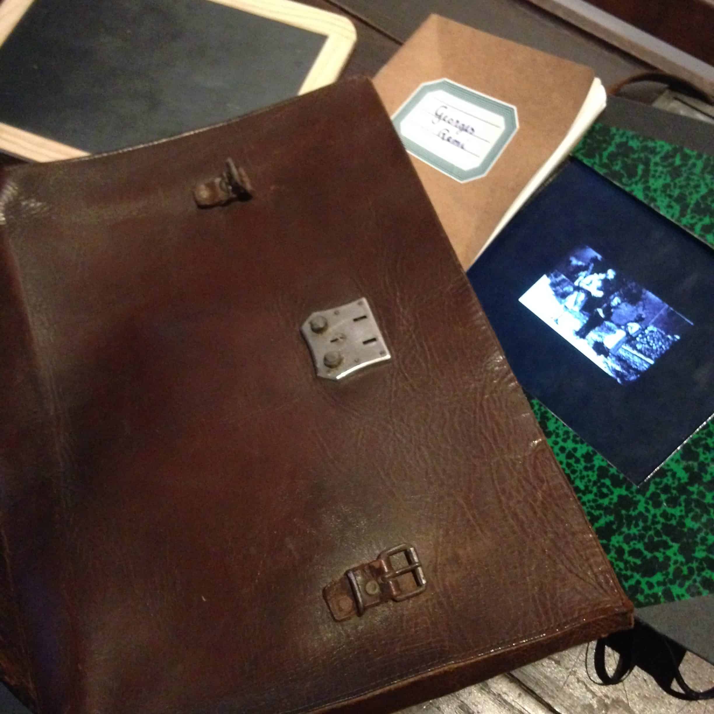 Hergé's leather satchel and notebooks for reference sketches and ideas  – Hergé / Tintin artifacts in Québec City